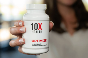 Close-up of a person holding a bottle of 10X Health Optimize Multivitamin, showcasing the front label of the supplement.