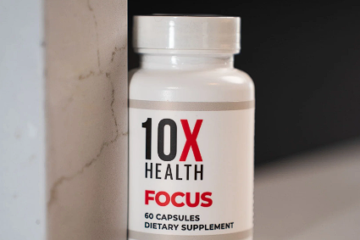 Close-up of 10X Health Focus supplement bottle, positioned against a wall.