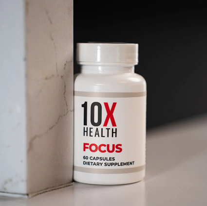 Close-up of 10X Health Focus supplement bottle, positioned against a wall.